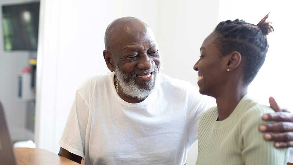 Man smilling because his mental health is good and hugging a woman